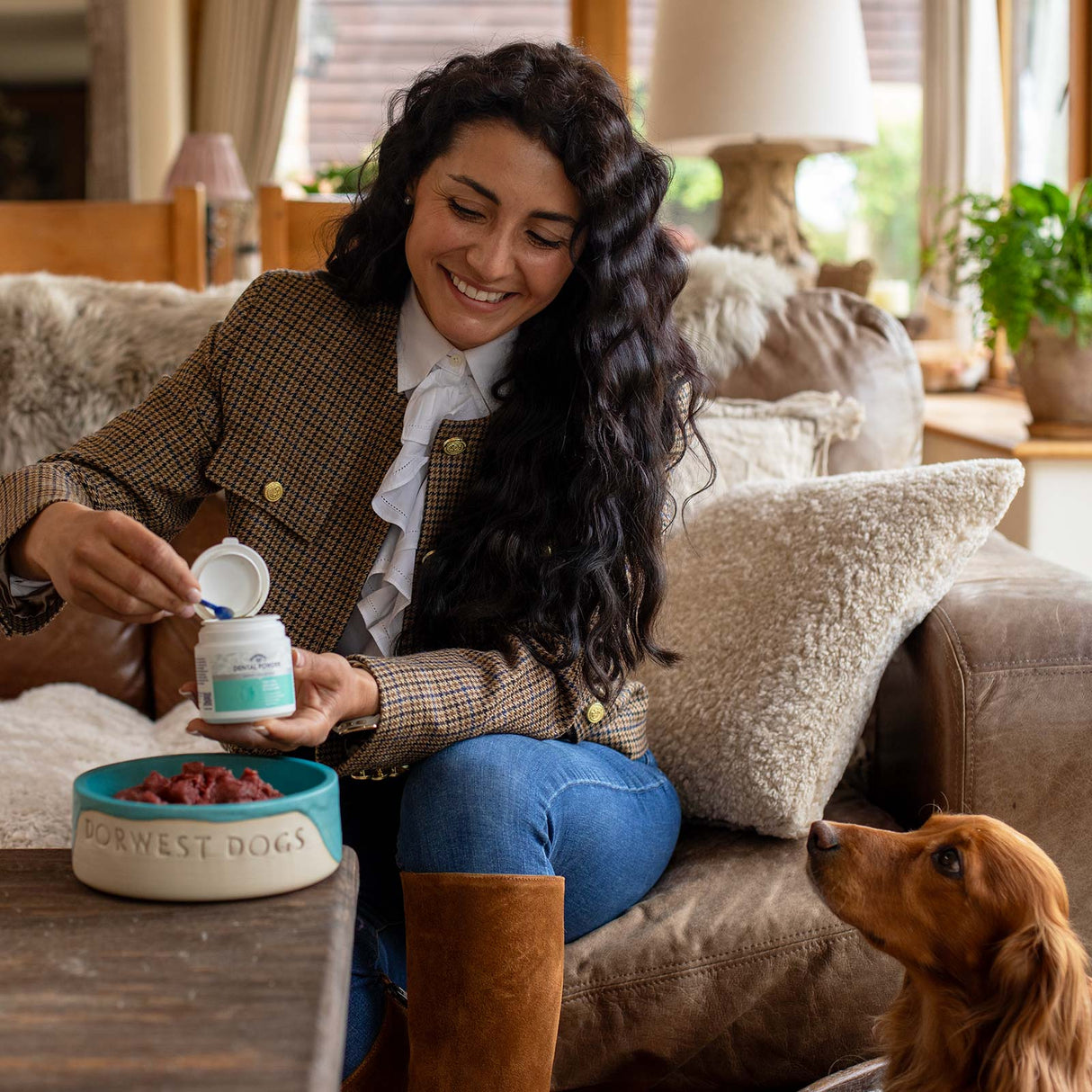 Woman feeding dental powder to dog